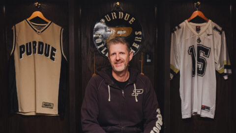 Eric Jakubiak poses in the lockers he built to house his Purdue memorabilia collection.