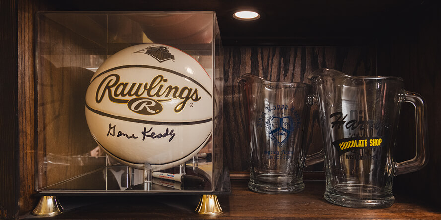 A basketball autographed by former Purdue basketball coach Gene Keady and drinkware from Alpha Kappa Lambda fraternity and Harry’s Chocolate Shop