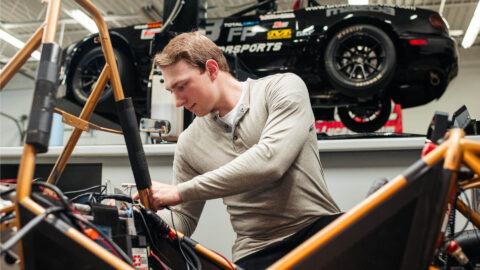 Reed England, a Purdue motorsports engineering student in Indianapolis, working on a project in the Stutz Building motorsports engineering lab.