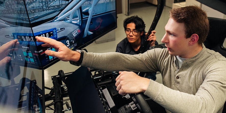 England and another motorsports club member utilize the on-campus motorsports engineering lab simulator