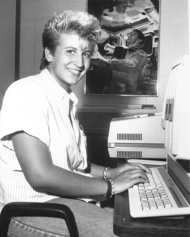 Julie Kramer White types on a computer.