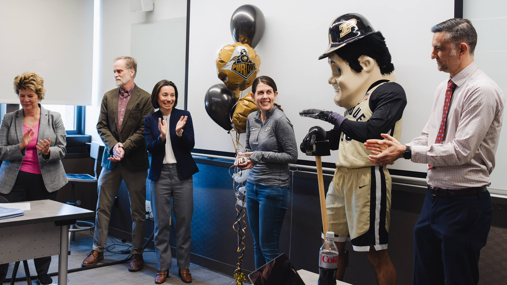 Betsy Parkinson, assistant professor of chemistry and medicinal chemistry and molecular pharmacology, celebrates the surprise announcement of her Exceptional Early Career Teaching Award.