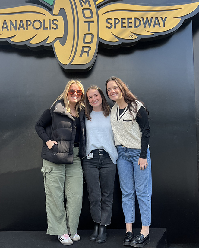 Erica Hedrick poses for a photo with friends at the Indianapolis Motor Speedway. 