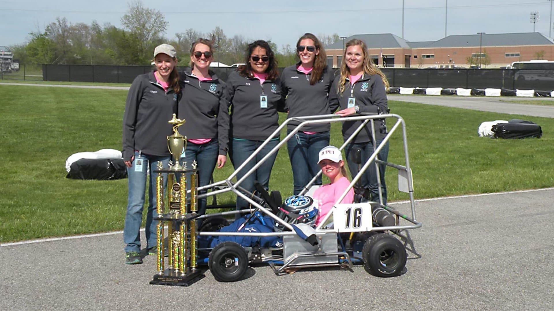 Lizzie Todd and her Society of Women Engineers teammates with their second-place car at the Purdue Grand Prix