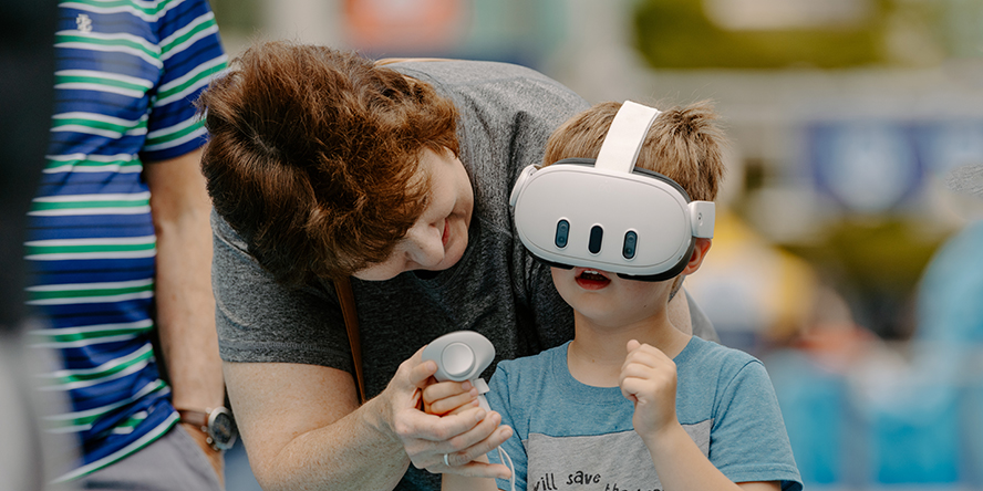 A child plays a virtual reality swimming simulator at USA Swimming LIVE presented by Purdue.