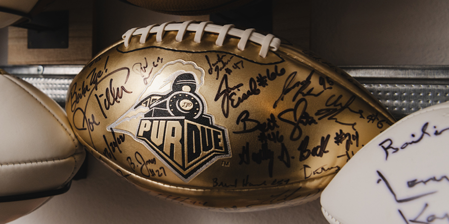 A gold Purdue football autographed by former Boilermakers coach Joe Tiller and others. 