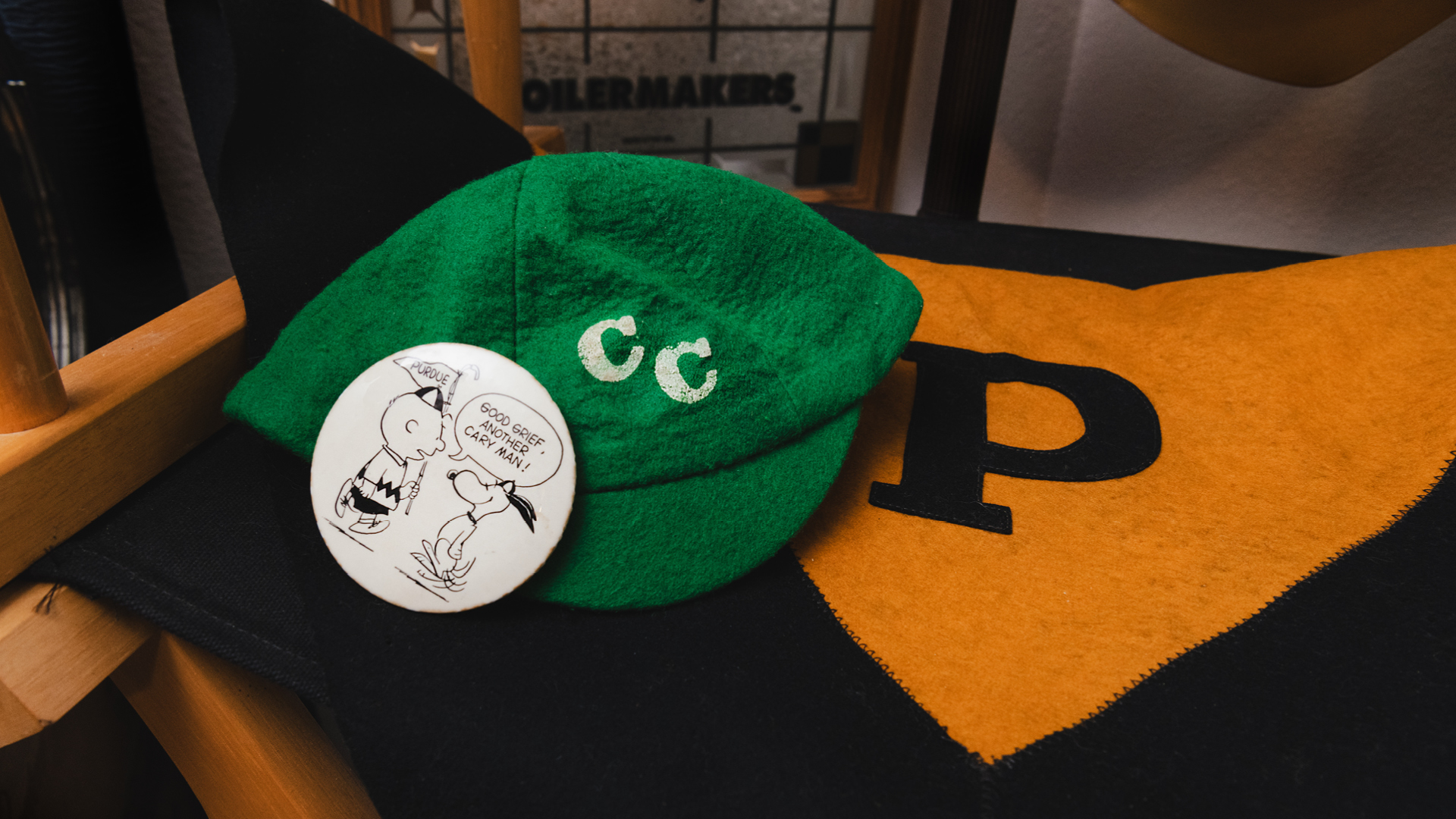 A vintage beanie from Cary Quadrangle Residence Hall and “Peanuts” button.