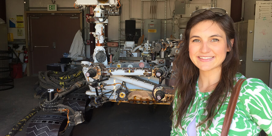 Sheridan Moore next to NASA’s Mars Science Laboratory Curiosity Rover.