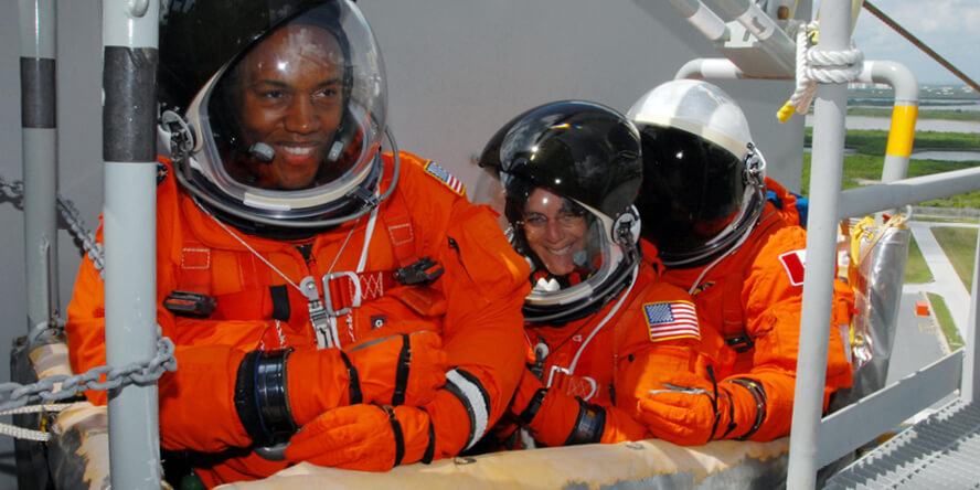 Barbara Morgan with two STS-118 crew members.