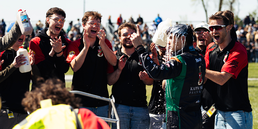 The Kappa Sigma Racing A team cheers with driver Raif Shah after winning the 2025 Purdue Grand Prix