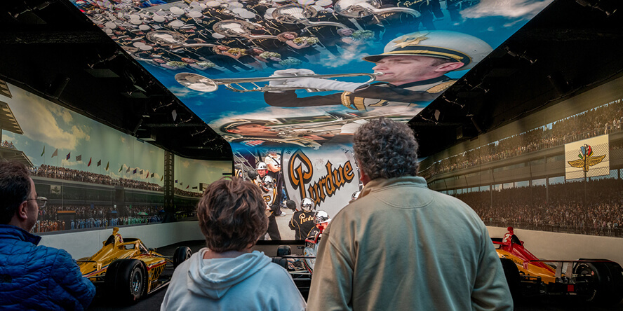 IMS Museum guests watch a video simulating the start of the Indy 500.