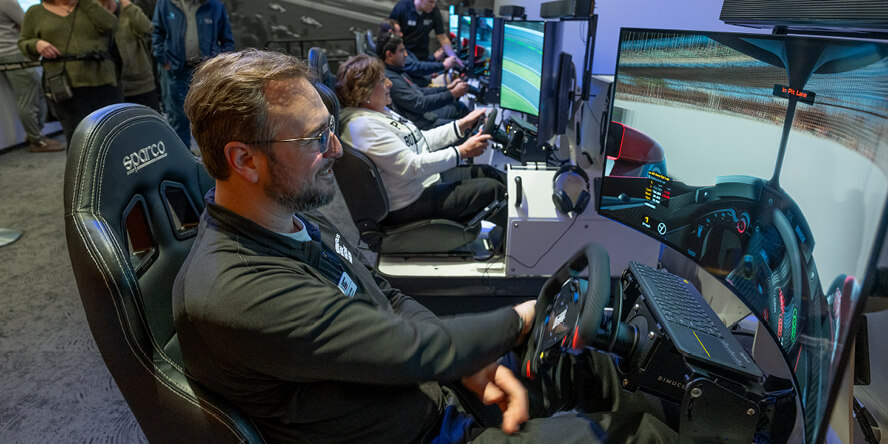 Purdue alumnus Brian Bobay drives a racing simulator.