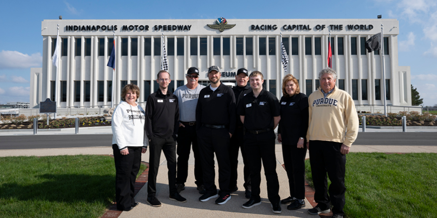 Brian Bobay stands with a group of IMS Museum colleagues who are also Purdue alums.