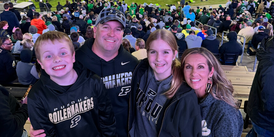 Greg Etter with his wife and two of their children at a Purdue football game.