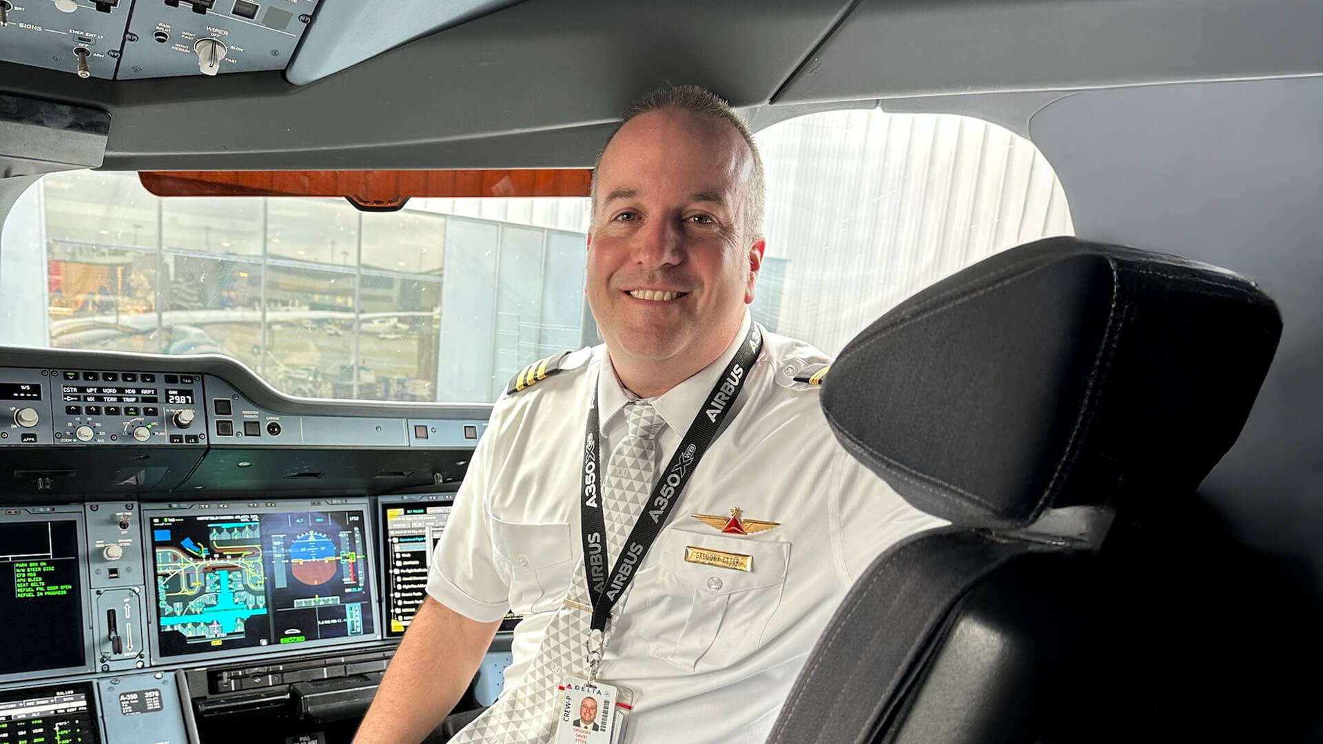 Greg Etter sitting in the cockpit of a plane.