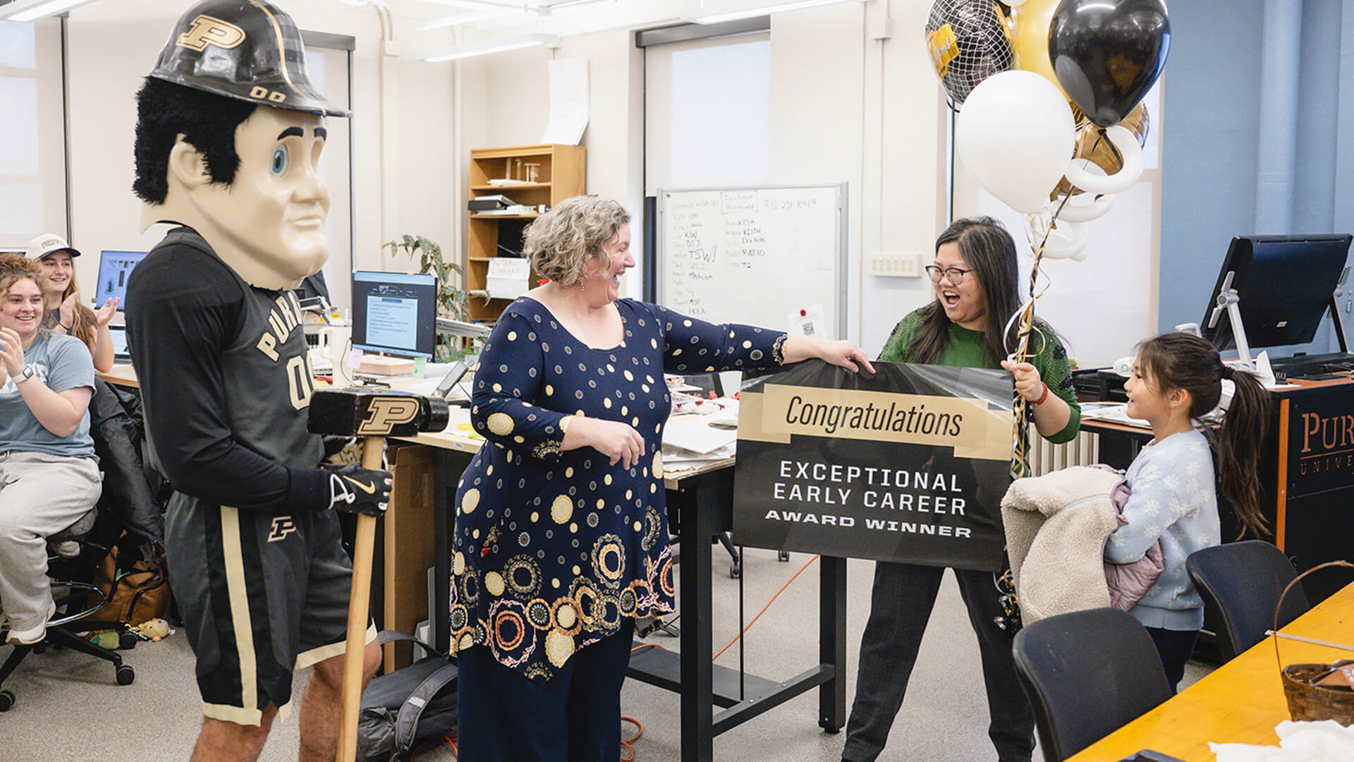 Purdue assistant professor Yiwei Huang is surprised with a teaching award during class.