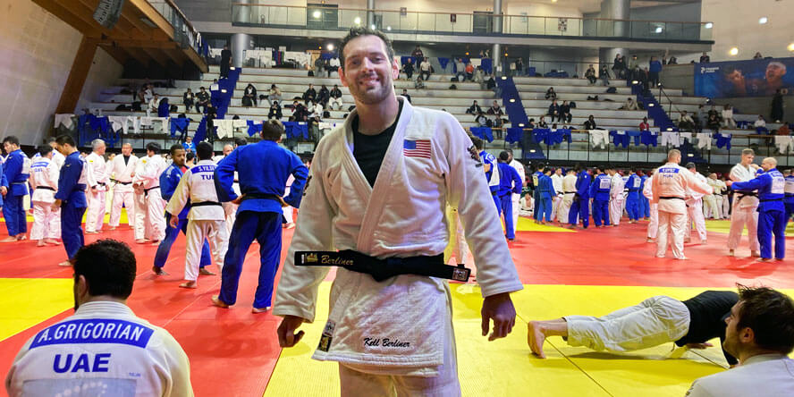 Berliner smiles on the mat at a tournament. 