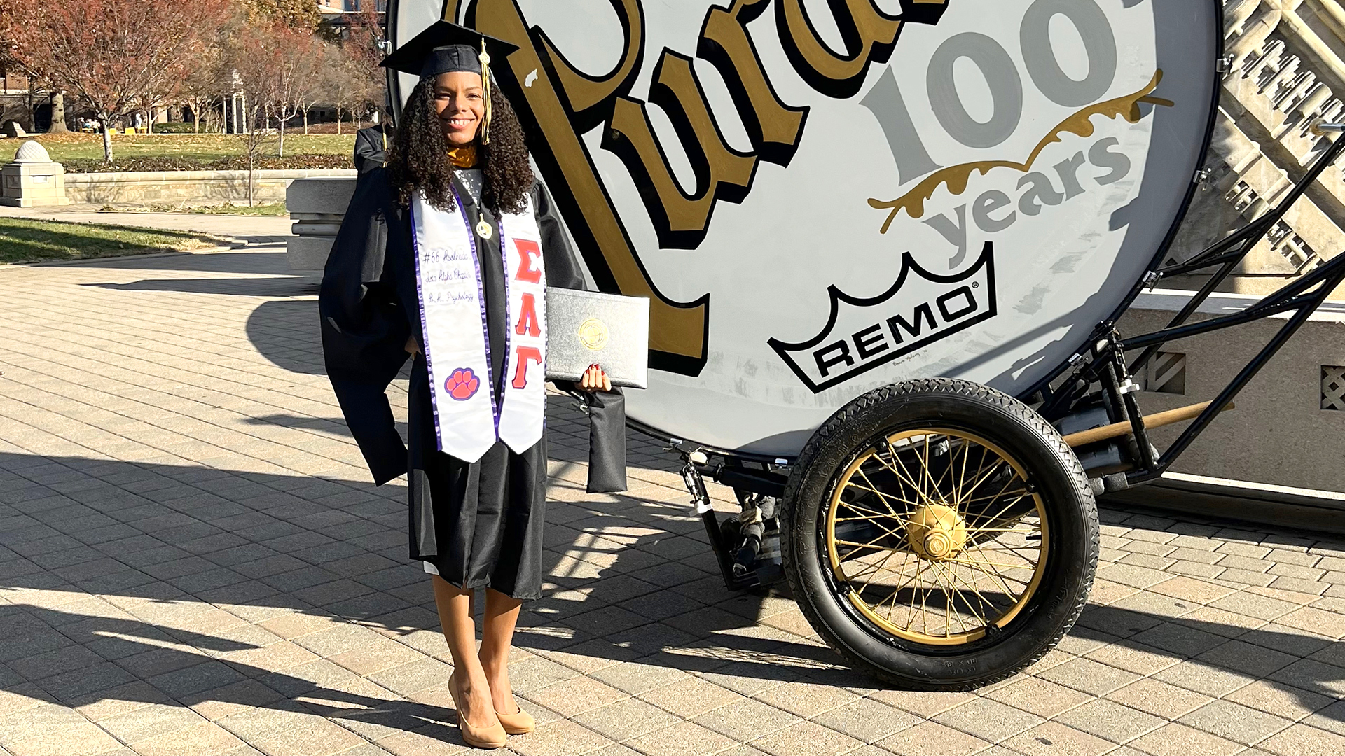 Nicole Richardson Hicks stands next to drum.