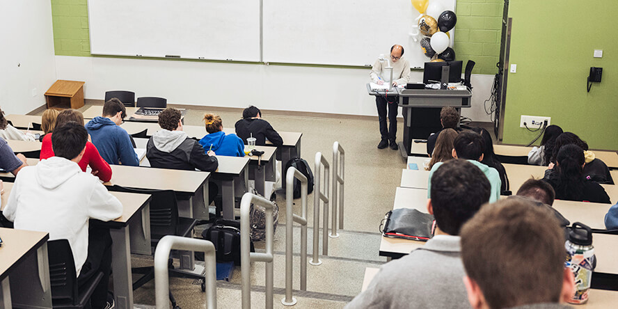 Kuan-Hua “Joe” Chen teaches math while his students take notes and listen.