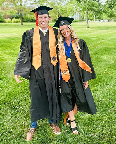 Leighellen and her son, Jacoby, stand outside in their matching caps and gowns.