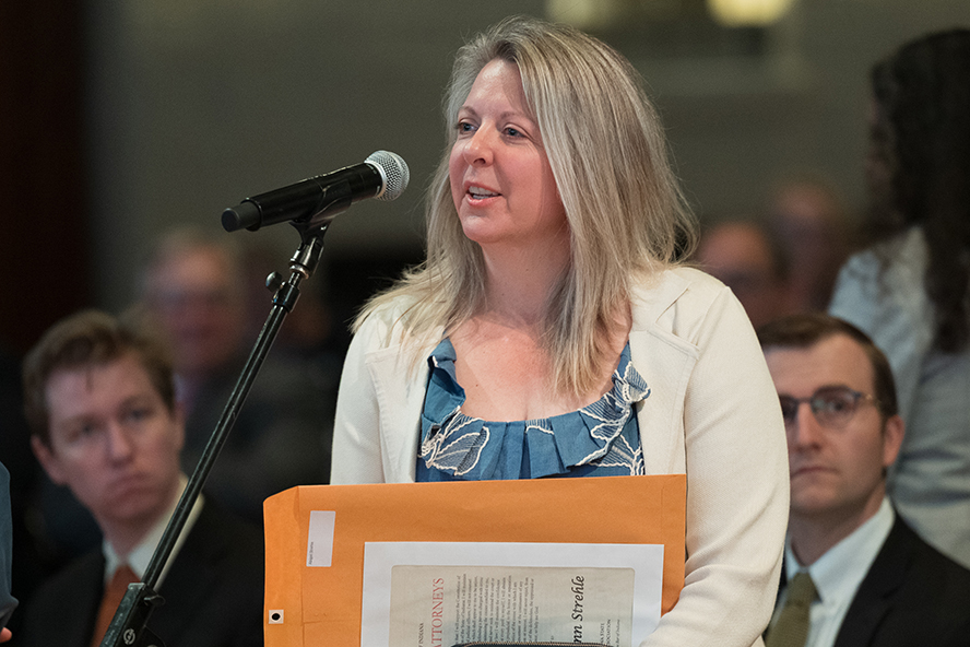 Abby Strehle speaking at a microphone at the Indiana Bar Admission Ceremony.