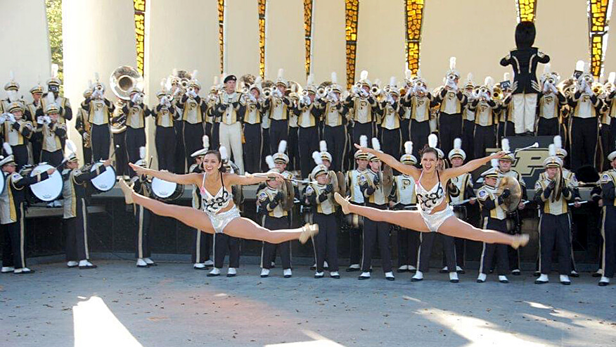 Sara and Chellie Zou in front of other members of the “All-American” Marching Band.