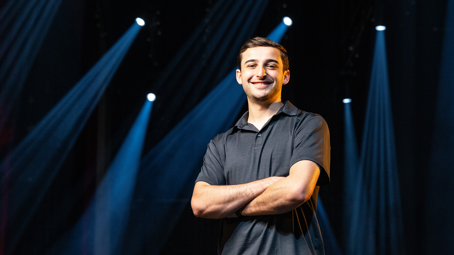 Robert Cohen standing under theater lights.