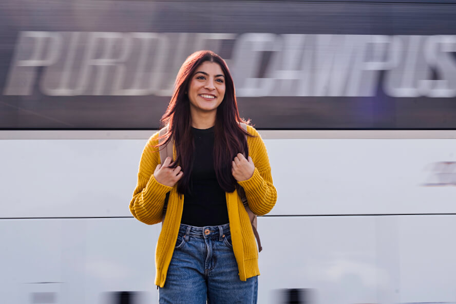 Janvi Prasad stands in front of the Campus Connect Shuttle in West Lafayette.