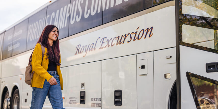 Janvi Prasad walks in front of the Campus Connect Shuttle in West Lafayette.