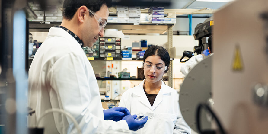 Associate professor Babak Anasori speaks with undergraduate researcher Janvi Prasad in his lab.