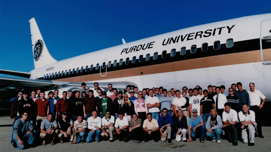 Nathan Malafa in front of a Purdue-branded plane.