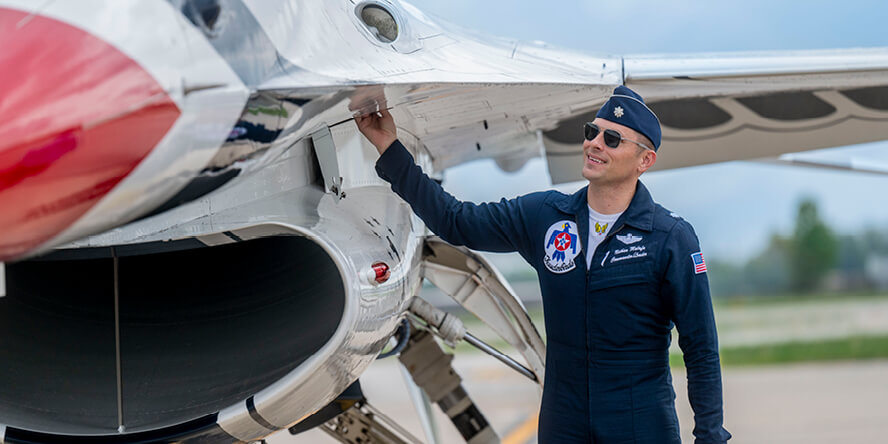 Nathan Malafa touching the side of a plane.
