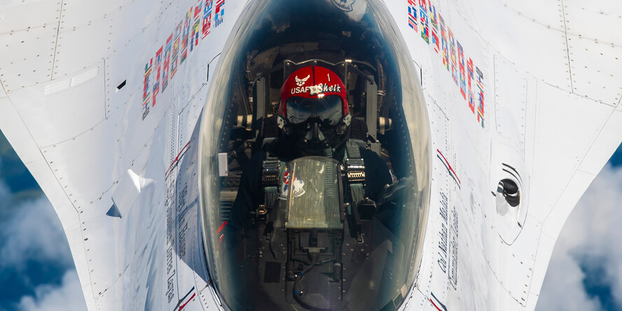 A pilot sitting in a plane’s cockpit.