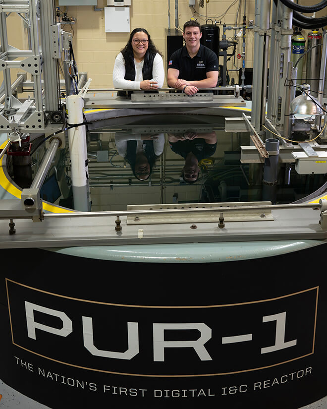 Purdue graduate students Hannah Pike and Ryan Hogg at the PUR-1 nuclear reactor