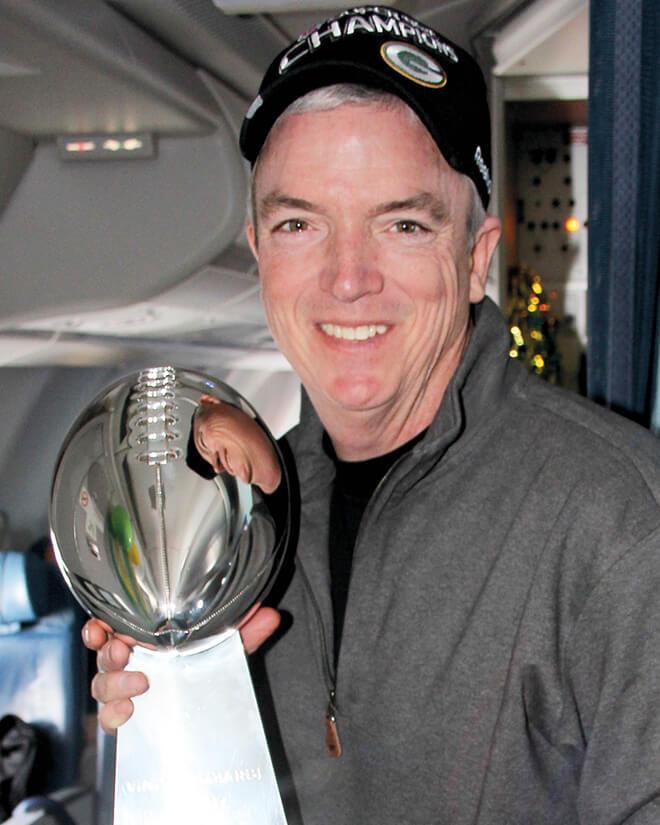 Pepper Burruss holds the Lombardi Trophy after the Green Bay Packers’ Super Bowl win.