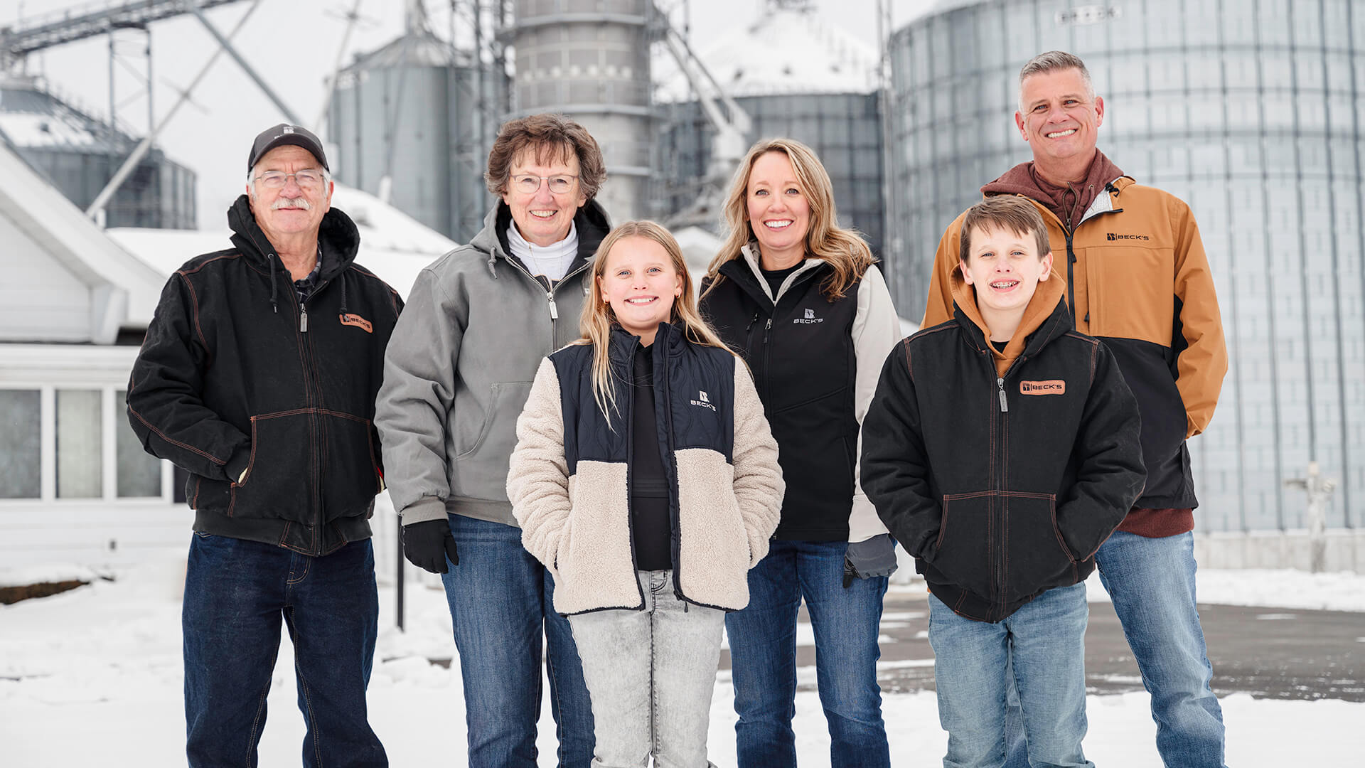 Bethany Gremel, her parents, husband and two children stand for a photo on their Indiana farm. 