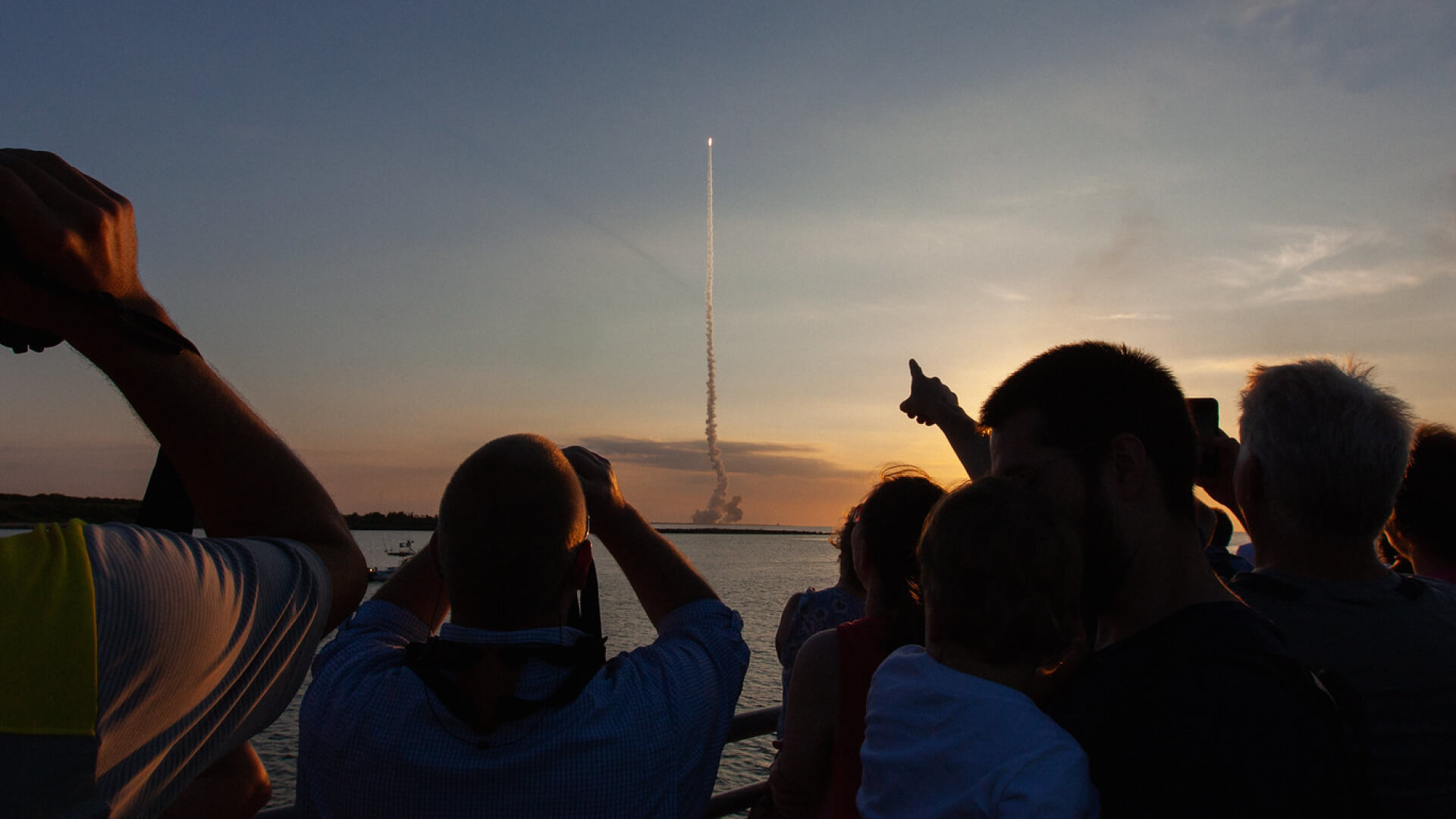 A crowd at Kennedy Space Center watches Artemis II’s liftoff