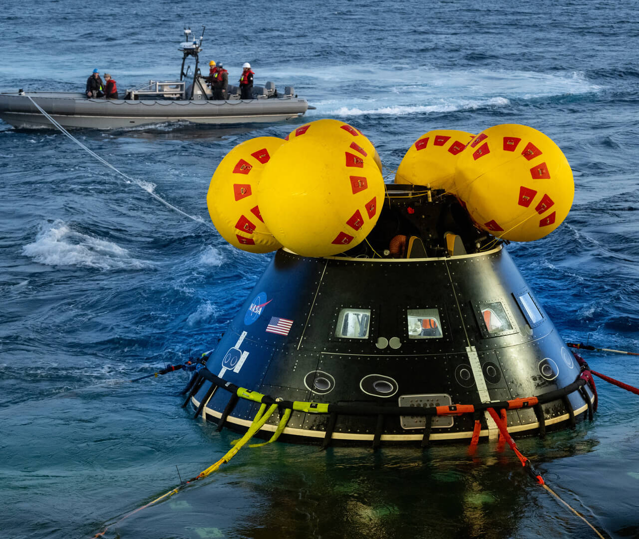 The recovery team practices a water recovery by connecting with a practice crew module