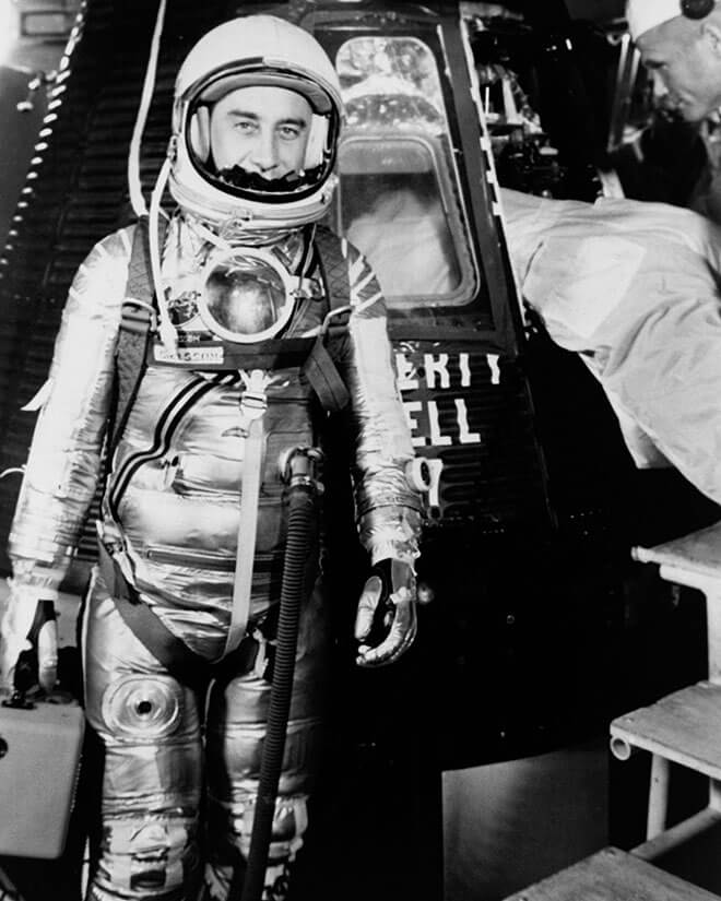 Gus Grissom in his spacesuit, standing next to the Liberty Bell 7 capsule