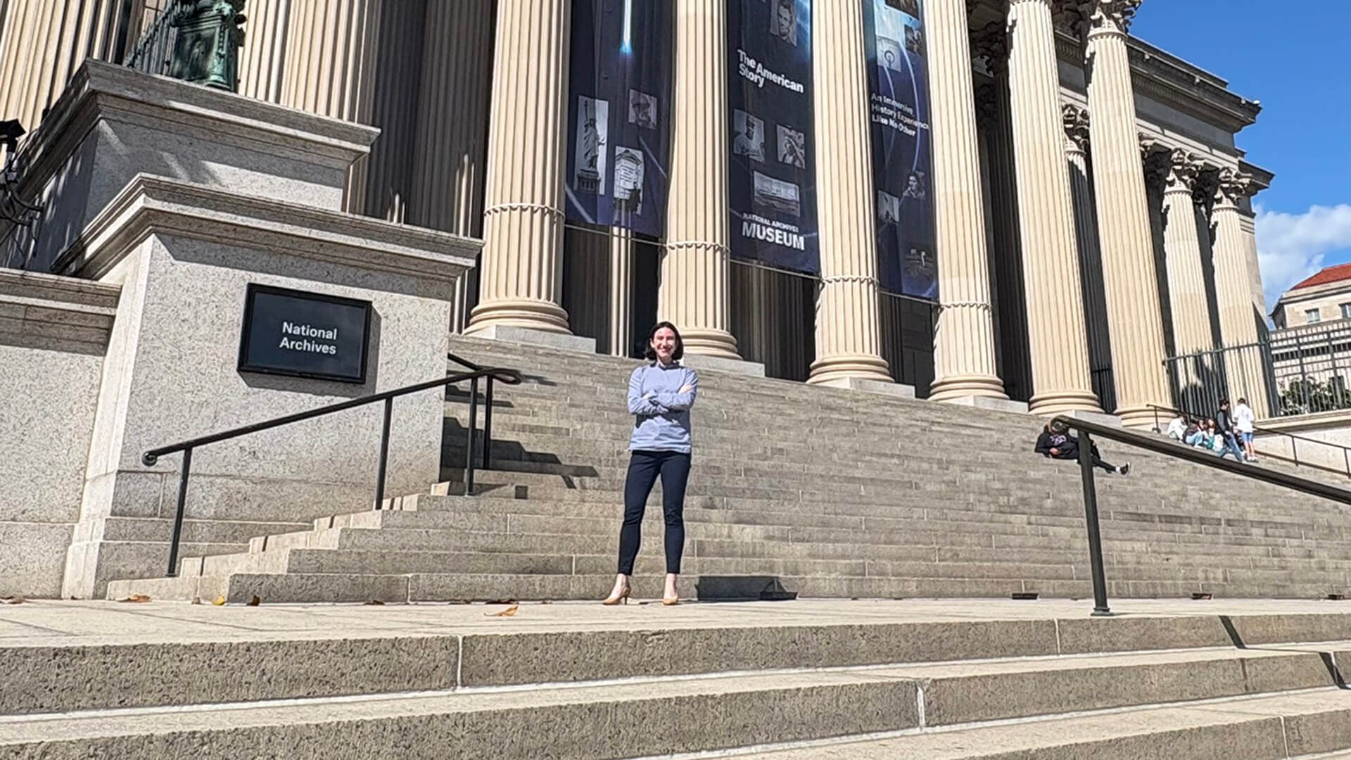 Purdue alum Caroline Shanley stands on the steps of the National Archives Building in Washington, D.C.
