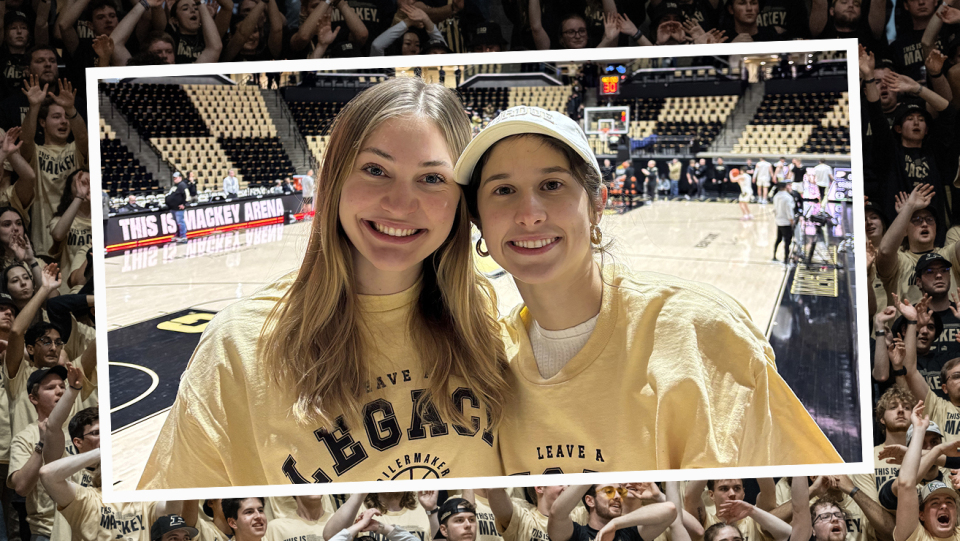Two students smiling at a Purdue basketball game in Mackey Arena.