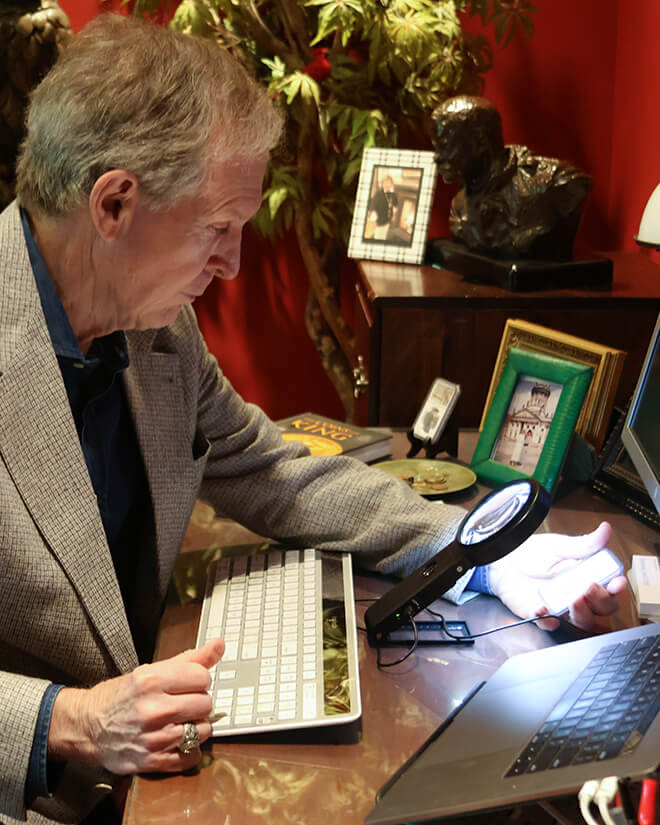 Michael Moran inspecting a coin.