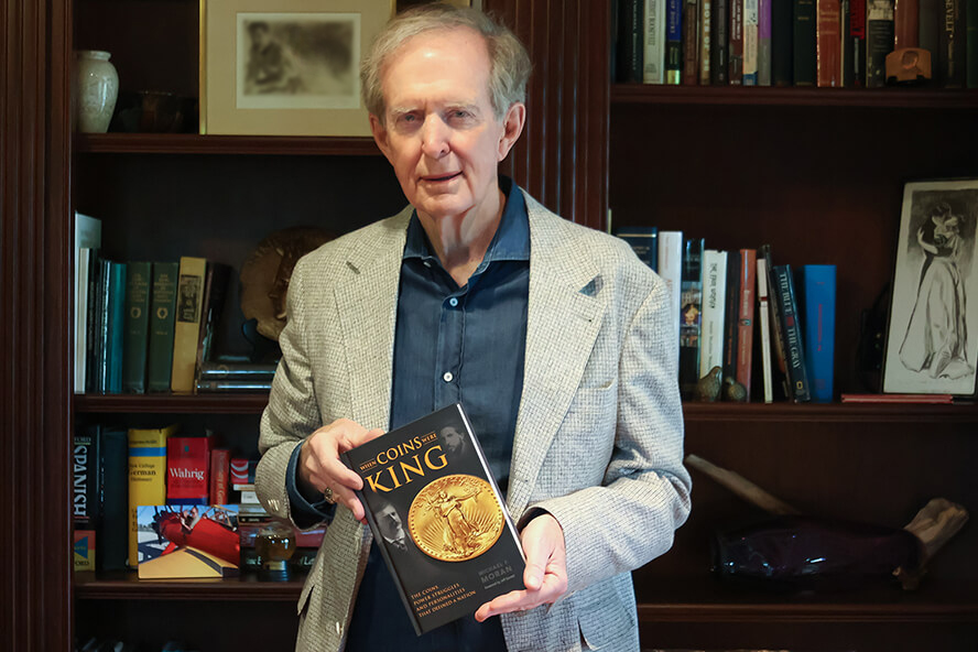 Michael Moran holding his book, “When Coins Were King: The Coins, Power Struggles, and Personalities That Defined a Nation”
