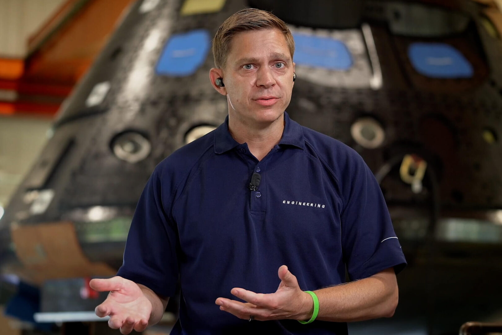 Mark Baldwin speaks with the Orion capsule in the background 