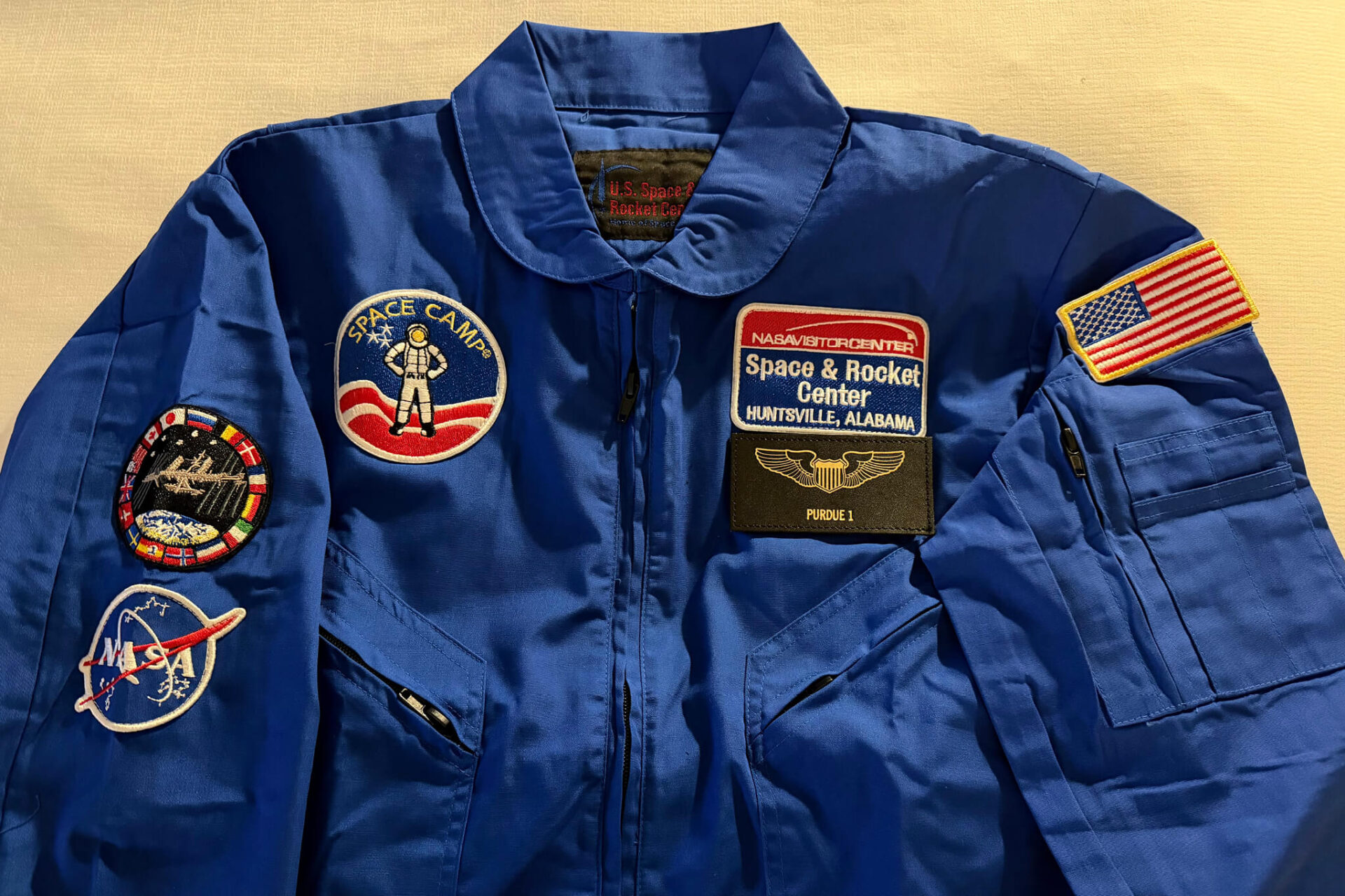 The blue flight suit Jason Williamson wore at the Adult Advanced Space Academy, featuring a patch highlighting his status as a Purdue 1 crew member