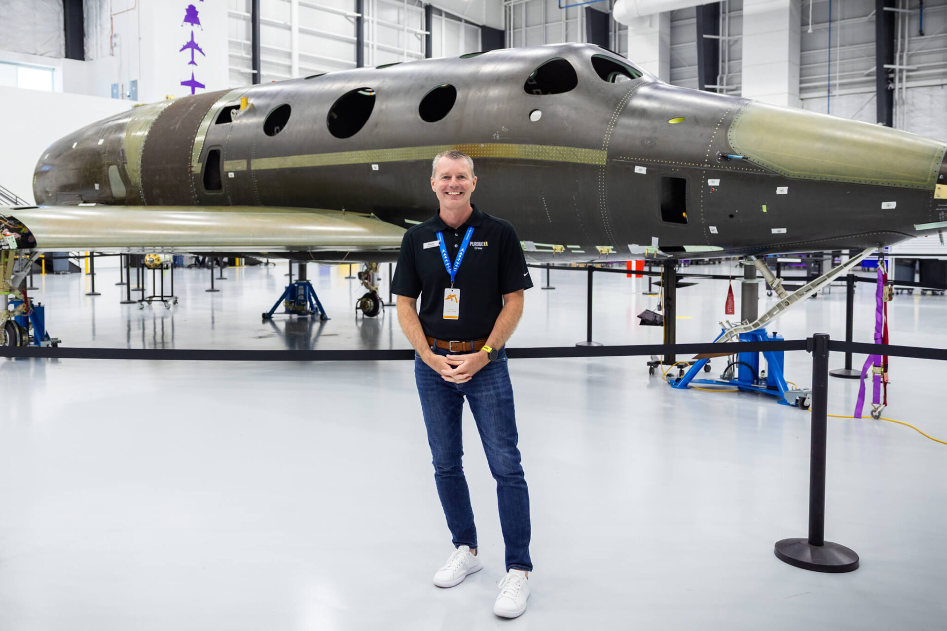 Jason Williamson poses for a photo in front of the new Virgin Galactic Delta-class spaceship that will carry the Purdue 1 crew