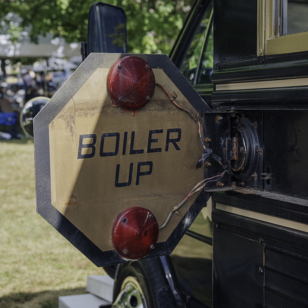The back of the bus stop-arm, painted with the phrase “Boiler Up.”