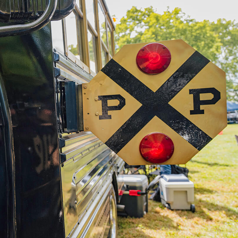 The front of the bus stop-arm, painted to look like a railroad crossing sign.