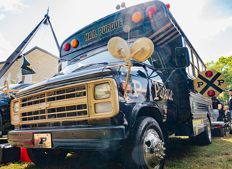 A photo of the front of the bus taken while standing near its driver side.