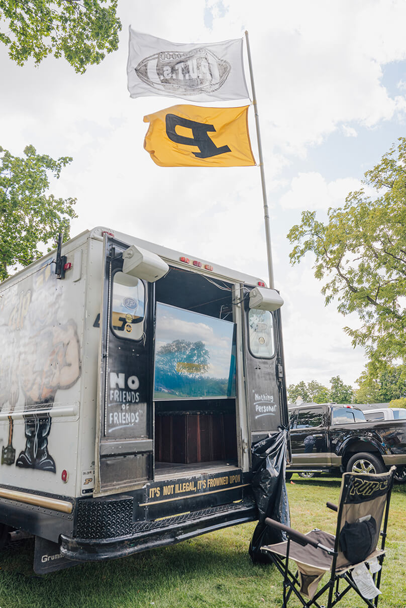 The back of the bread truck with a Purdue flag flying above it.
